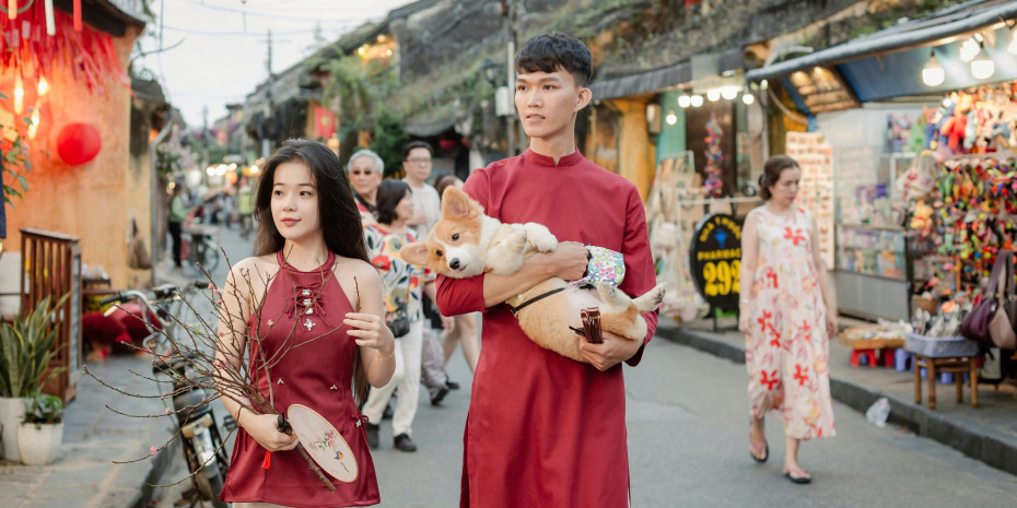 Young asian couple strolling with a dog